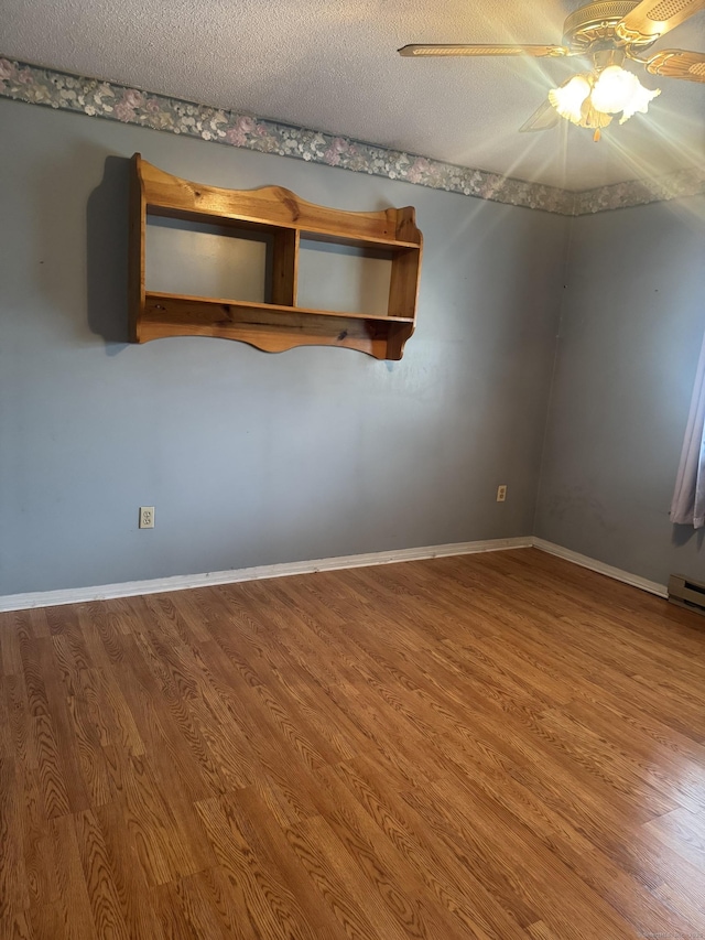 260 Scott Rd Apt 1, Waterbury, CT 06705 - empty room featuring wood finished floors, a ceiling fan, a textured ceiling, and a baseboard radiator