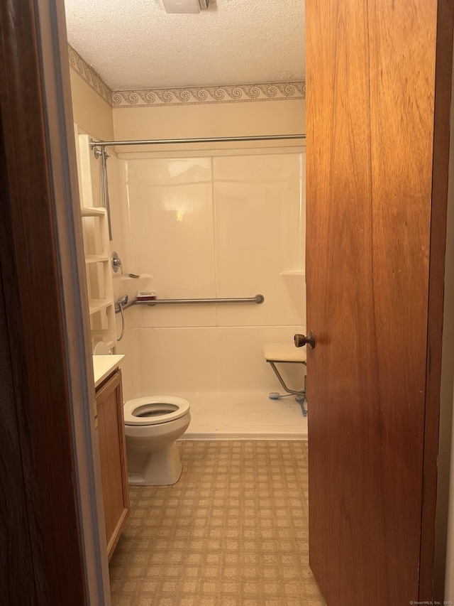 260 Scott Rd Apt 1, Waterbury, CT 06705 - full bathroom featuring tile patterned floors, a shower, vanity, and a textured ceiling