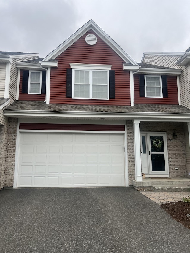 90 Bridlewood Ln Unit 90, Vernon, CT 06066 - traditional-style house featuring driveway, an attached garage, brick siding, and a shingled roof