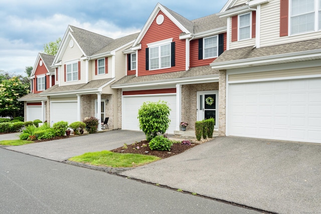 90 Bridlewood Ln Unit 90, Vernon, CT 06066 - townhome / multi-family property featuring a garage, driveway, a shingled roof, and brick siding