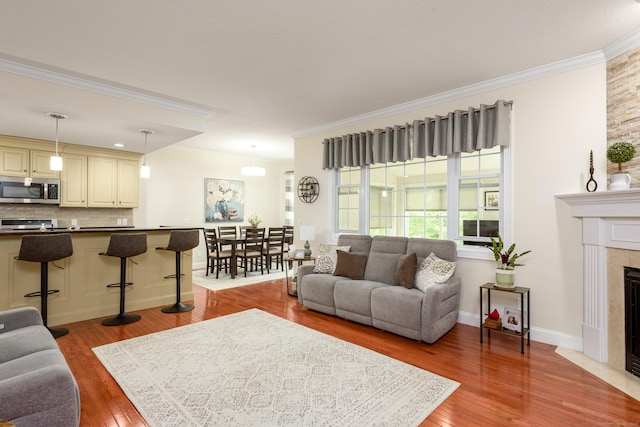 90 Bridlewood Ln Unit 90, Vernon, CT 06066 - living area with crown molding, wood finished floors, and a tile fireplace