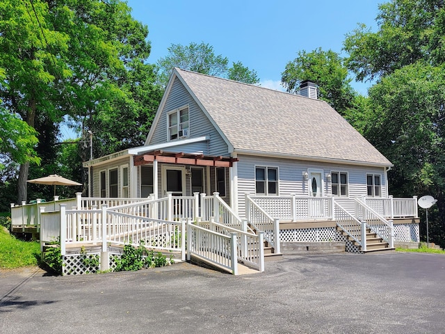 43 Rte 87, Columbia, CT 06237 - view of front facade featuring a shingled roof, a chimney, and a deck