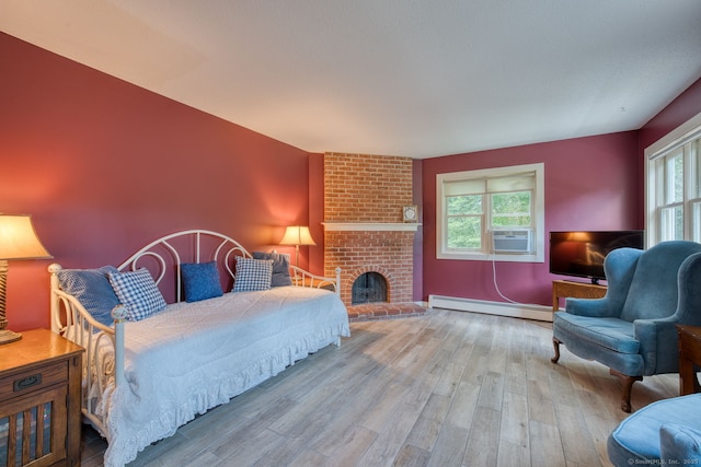 43 Rte 87, Columbia, CT 06237 - bedroom featuring baseboard heating, wood finished floors, cooling unit, and a fireplace