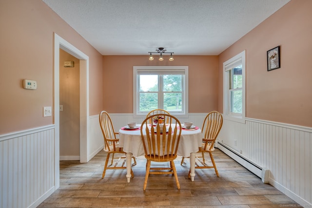 43 Rte 87, Columbia, CT 06237 - dining room featuring a baseboard heating unit, wainscoting, wood finished floors, and a textured ceiling