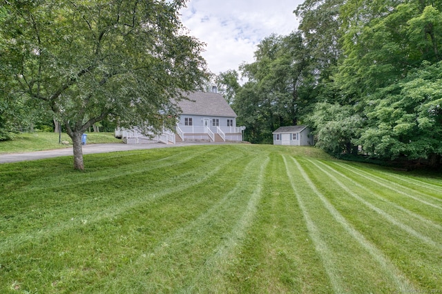 43 Rte 87, Columbia, CT 06237 - view of green lawn with asphalt driveway, a shed, a porch, and stairs