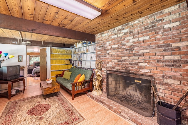 88 Hillyndale Rd, Mansfield, CT 06268 - living area with a wooden ceiling with exposed beams, wood finished floors, and brick wall
