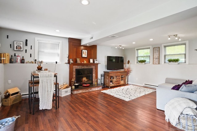 296 Black Rock Tpke, Redding, CT 06896 - living room with wood finished floors, a baseboard heating unit, a brick fireplace, and recessed lighting
