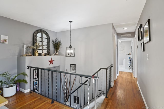 296 Black Rock Tpke, Redding, CT 06896 - corridor with an upstairs landing, wood finished floors, and a chandelier