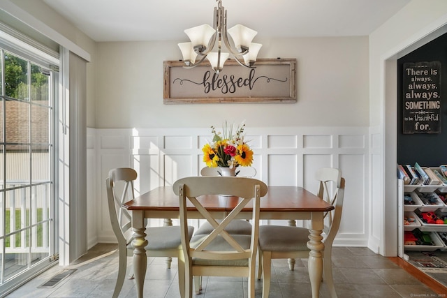 36 Ernest Ave, Waterbury, CT 06708 - dining space with a decorative wall, a chandelier, and a wainscoted wall