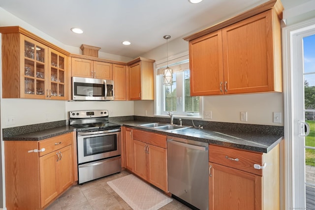 36 Ernest Ave, Waterbury, CT 06708 - kitchen with appliances with stainless steel finishes, dark countertops, glass insert cabinets, recessed lighting, and hanging light fixtures