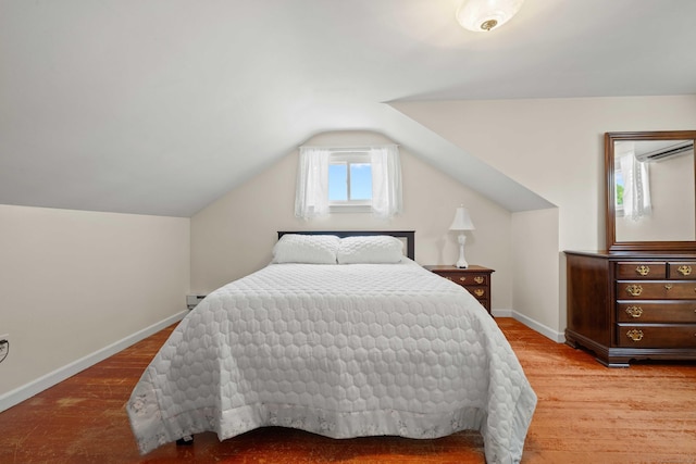 376 Glenwood Avenue Extension, Waterford, CT 06385 - bedroom featuring an AC wall unit, vaulted ceiling, and wood finished floors