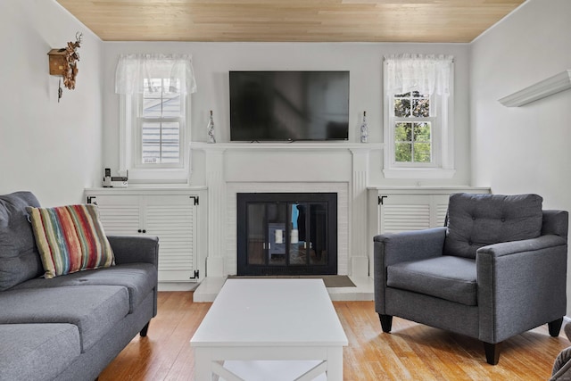 376 Glenwood Avenue Extension, Waterford, CT 06385 - living area with wood ceiling, a glass covered fireplace, and light wood-style floors