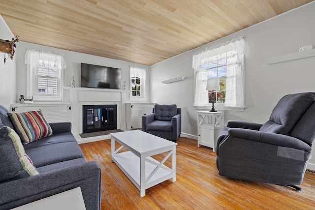 376 Glenwood Avenue Extension, Waterford, CT 06385 - living area with wood ceiling, healthy amount of natural light, a glass covered fireplace, and light wood-style floors