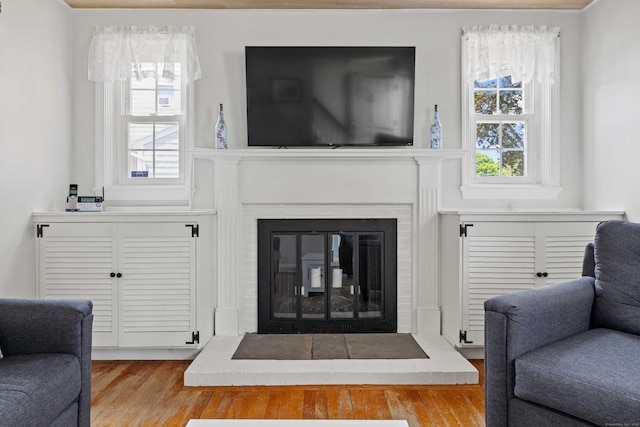 376 Glenwood Avenue Extension, Waterford, CT 06385 - living area featuring a glass covered fireplace and wood finished floors