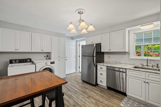 376 Glenwood Avenue Extension, Waterford, CT 06385 - kitchen featuring appliances with stainless steel finishes, washing machine and clothes dryer, white cabinetry, a chandelier, and light wood-style floors