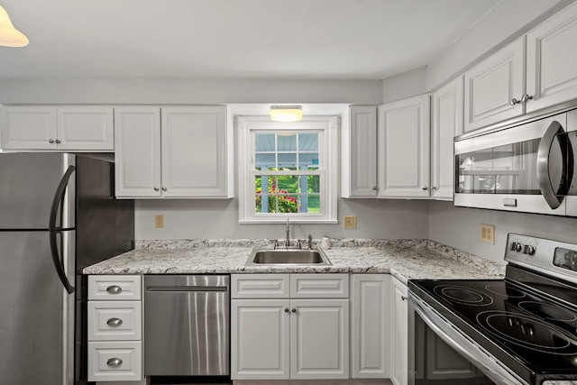 376 Glenwood Avenue Extension, Waterford, CT 06385 - kitchen with appliances with stainless steel finishes, white cabinets, and light stone counters