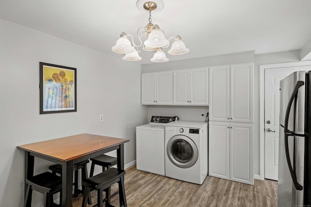 376 Glenwood Avenue Extension, Waterford, CT 06385 - laundry area featuring cabinet space, washing machine and clothes dryer, a chandelier, and light wood-type flooring