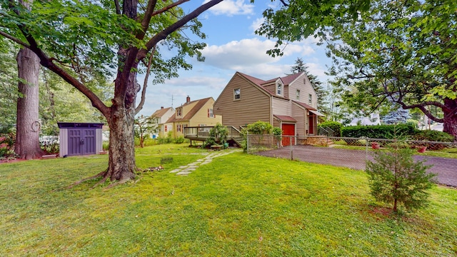 166 Catherine St, Hartford, CT 06106 - view of yard with asphalt driveway, a storage unit, and a garage