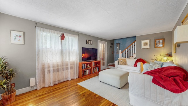 166 Catherine St, Hartford, CT 06106 - living room with a textured ceiling, wood finished floors, and stairway