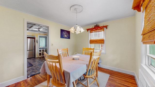 166 Catherine St, Hartford, CT 06106 - dining room featuring healthy amount of natural light, crown molding, a chandelier, and wood finished floors