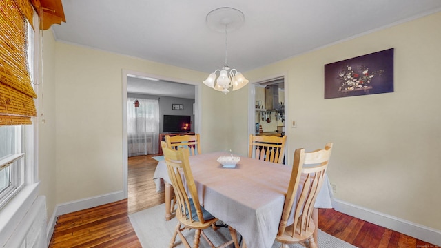 166 Catherine St, Hartford, CT 06106 - dining space with a chandelier, wood finished floors, and crown molding