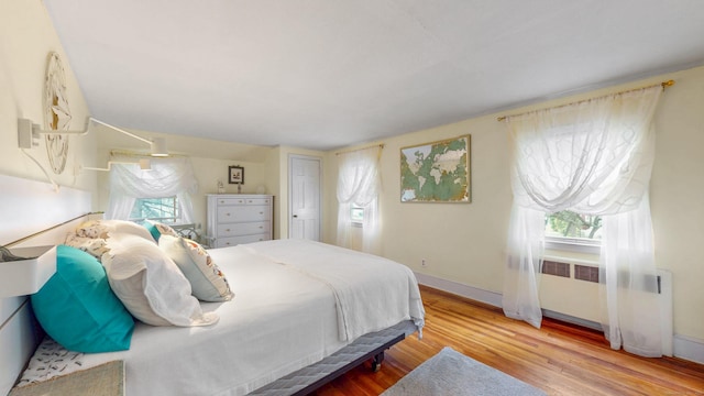 166 Catherine St, Hartford, CT 06106 - bedroom with wood finished floors, multiple windows, and radiator