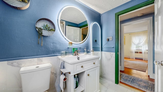 166 Catherine St, Hartford, CT 06106 - bathroom featuring vanity, radiator, a wainscoted wall, and marble look tiles