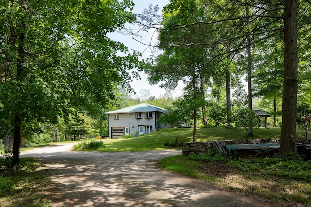 48 Preston Ln, Salisbury, CT 06068 - view of front of home featuring dirt driveway, an attached garage, a front yard, and stucco siding