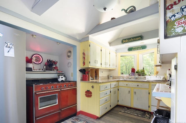 48 Preston Ln, Salisbury, CT 06068 - kitchen featuring stainless steel gas range, light countertops, cream cabinetry, wood finished floors, and vaulted ceiling