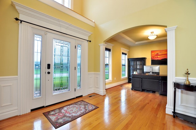 1 Leghorn Ln, Cromwell, CT 06416 - entryway featuring arched walkways, healthy amount of natural light, wainscoting, light wood-type flooring, and crown molding