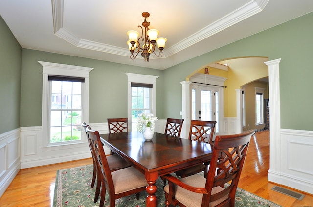 1 Leghorn Ln, Cromwell, CT 06416 - dining space featuring arched walkways, wainscoting, light wood-style floors, a chandelier, and ornamental molding