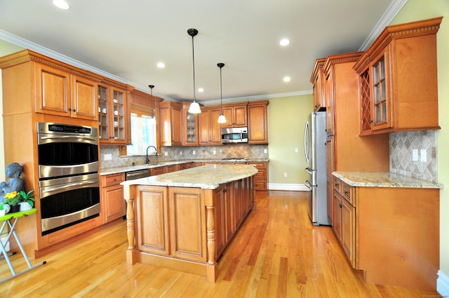 1 Leghorn Ln, Cromwell, CT 06416 - kitchen featuring appliances with stainless steel finishes, brown cabinets, a kitchen island, tasteful backsplash, and recessed lighting
