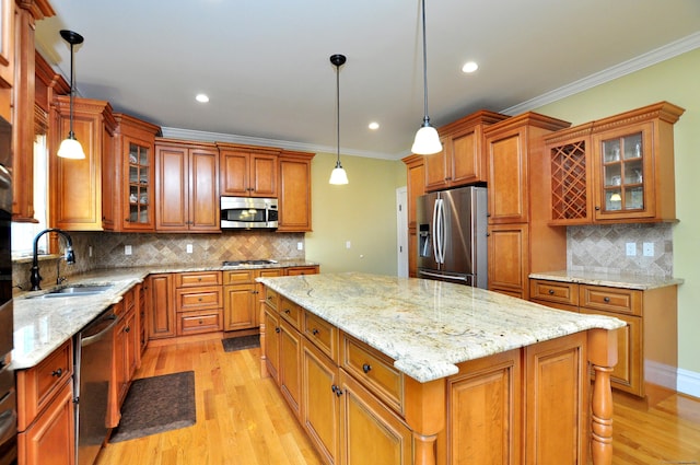 1 Leghorn Ln, Cromwell, CT 06416 - kitchen with stainless steel appliances, brown cabinets, light wood-type flooring, tasteful backsplash, and crown molding