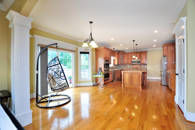 1 Leghorn Ln, Cromwell, CT 06416 - kitchen with appliances with stainless steel finishes, decorative columns, ornamental molding, a center island, and brown cabinetry