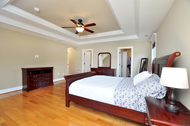1 Leghorn Ln, Cromwell, CT 06416 - bedroom featuring a tray ceiling, ornamental molding, wood finished floors, a walk in closet, and ceiling fan