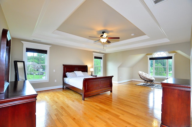 1 Leghorn Ln, Cromwell, CT 06416 - bedroom featuring a tray ceiling, multiple windows, light wood finished floors, crown molding, and a ceiling fan