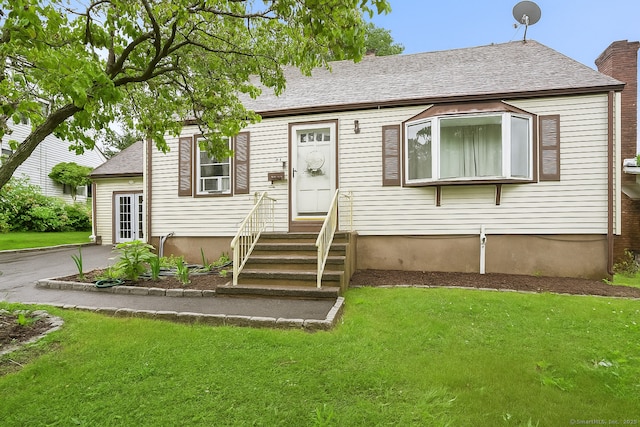 84 Hickory St, West Haven, CT 06516 - view of front of house with entry steps, a front lawn, a chimney, and roof with shingles