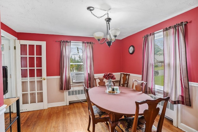 84 Hickory St, West Haven, CT 06516 - dining space with radiator, a chandelier, cooling unit, and light wood-style floors