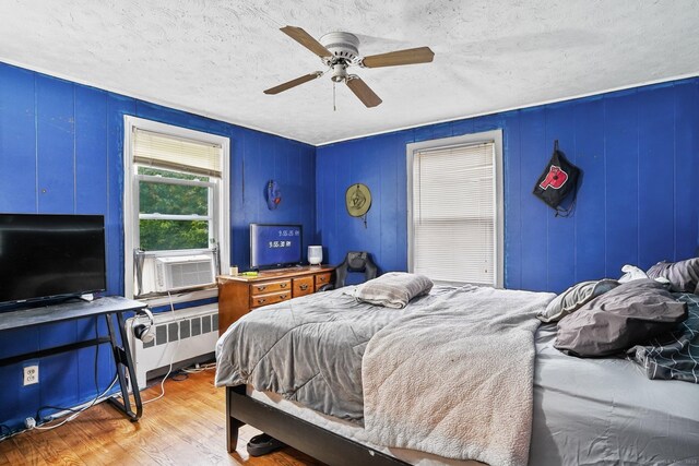 84 Hickory St, West Haven, CT 06516 - bedroom featuring a textured ceiling, wood finished floors, radiator, cooling unit, and ceiling fan
