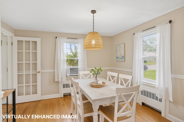 84 Hickory St, West Haven, CT 06516 - dining space with radiator, light wood-style floors, and cooling unit
