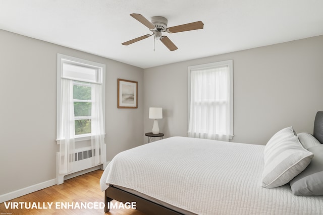 84 Hickory St, West Haven, CT 06516 - bedroom with light wood-style floors, radiator heating unit, and ceiling fan