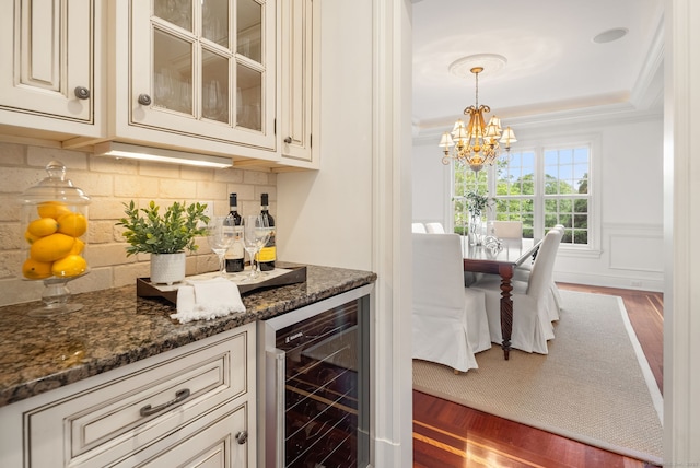 43 Chessor Ln, Wilton, CT 06897 - indoor dry bar with wine cooler, wood finished floors, decorative backsplash, crown molding, and a chandelier