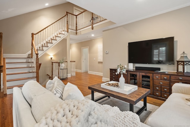43 Chessor Ln, Wilton, CT 06897 - living area with wood finished floors, recessed lighting, ornamental molding, stairway, and a towering ceiling