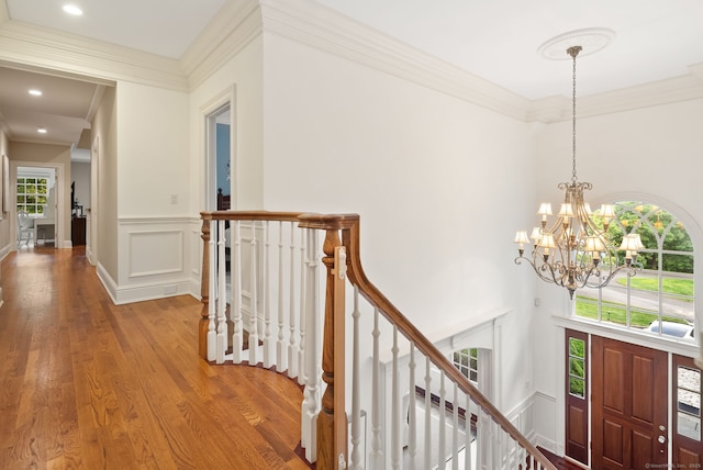 43 Chessor Ln, Wilton, CT 06897 - hallway with an upstairs landing, wood finished floors, a chandelier, ornamental molding, and wainscoting