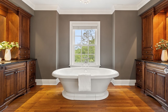 43 Chessor Ln, Wilton, CT 06897 - bathroom with a soaking tub, wood finished floors, and ornamental molding