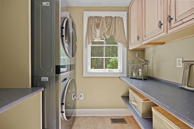67 Hayden Hill Rd, Haddam, CT 06438 - washroom featuring stacked washing machine and dryer, cabinet space, and tile patterned floors