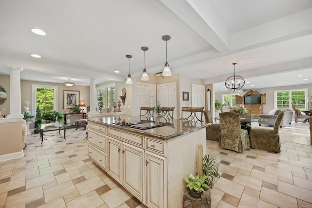 67 Hayden Hill Rd, Haddam, CT 06438 - kitchen featuring open floor plan, cream cabinets, black electric stovetop, decorative columns, and recessed lighting