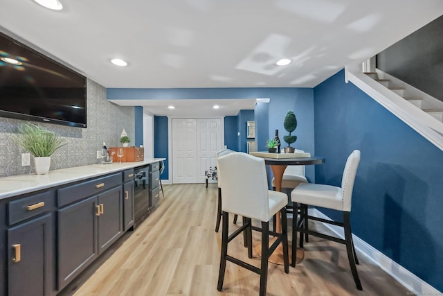 67 Hayden Hill Rd, Haddam, CT 06438 - dining space with light wood finished floors, recessed lighting, wine cooler, and stairway