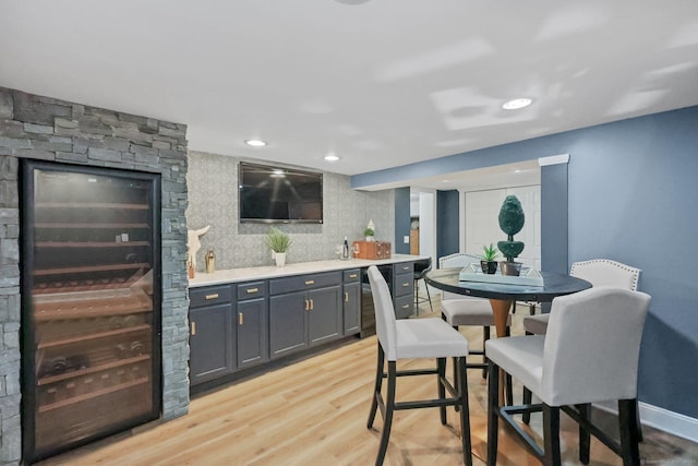 67 Hayden Hill Rd, Haddam, CT 06438 - dining space featuring wine cooler, bar with sink, and light wood-style floors