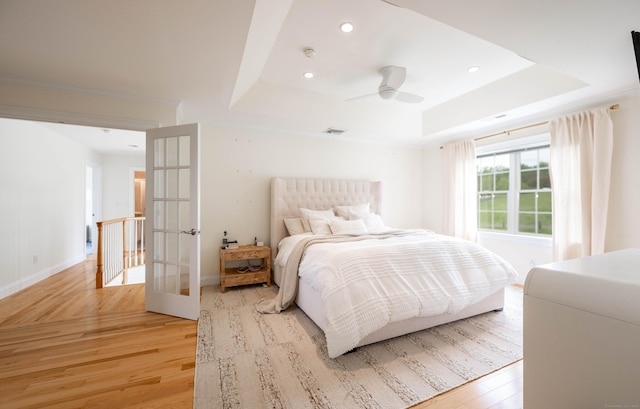 557 Upper Grassy Hill Rd, Woodbury, CT 06798 - bedroom with a tray ceiling, light wood-type flooring, french doors, recessed lighting, and ceiling fan